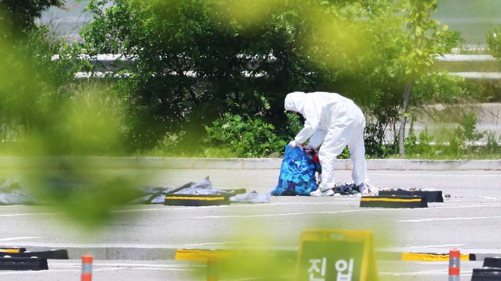 epa11385075 An official collects the debris of a balloon sent by North Korea at a shopping center in Siheung, west of Seoul, South Korea, 02 June 2024.  EPA/YONHAP SOUTH KOREA OUT