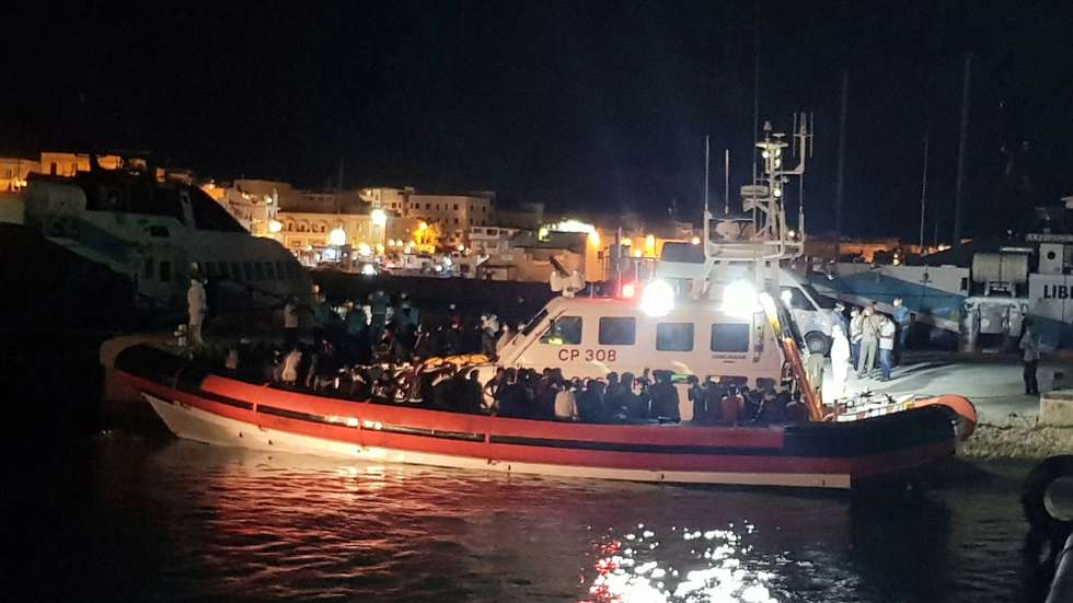 epaselect epa08644538 A boat with the 70 migrants recovered at sea by a patrol boat of the harbor master's office heads to the commercial pier of the island of Lampedusa, Sicilu Island, southern Italy, 03 September 2020. Accompanying operations in the reception center are underway. The conditions inside the center are already very difficult and this new landing puts the police and the men who manage the hotspot in further difficulty, who have been working in extreme conditions for months.  EPA/ELIO DESIDERIO