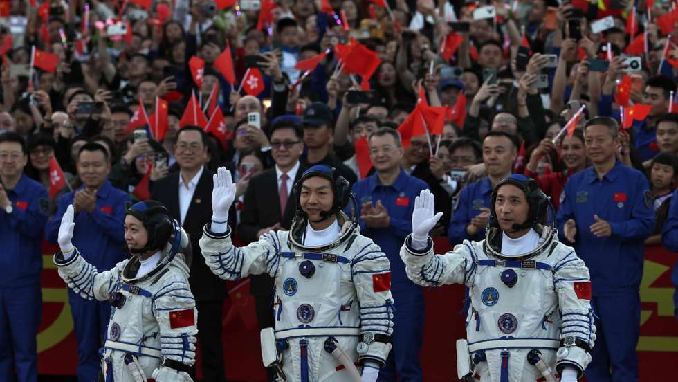 epa12990113 (L-R) Shenzhou-23 space mission astronauts Li Jiaying, Zhang Zhiy and Zhu Yangzhu greet members of the public during the seeing-off ceremony at the Jiuquan Satellite Launch Center near Jiuquan, China, 24 May 2026. The Shenzhou-23 space mission will be carried by a Long March 2F rocket.  EPA/ANDRES MARTINEZ CASARES