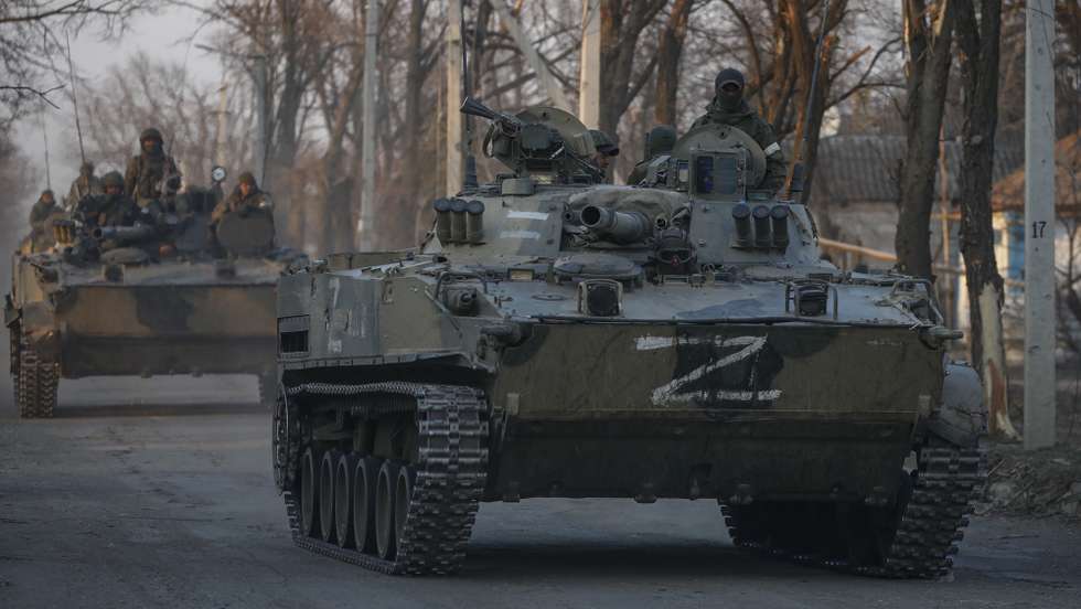 epa09851772 Russian servicemen drive on the infantry armoured vehicles in downtown Volnovakha, Ukraine, 26 March 2022. Troops of the self-proclaimed Donetsk People's Republic with Russian support entered Volnovakha, a small town near Donetsk. Donetsk People's Republic official said that the housing stock of the city of Volnovakha was destroyed by 85 percent, the city would have to be rebuilt. On 24 February Russian troops had entered Ukrainian territory in what the Russian president declared a 'special military operation', resulting in fighting and destruction in the country, a huge flow of refugees, and multiple sanctions against Russia.  EPA/SERGEI ILNITSKY