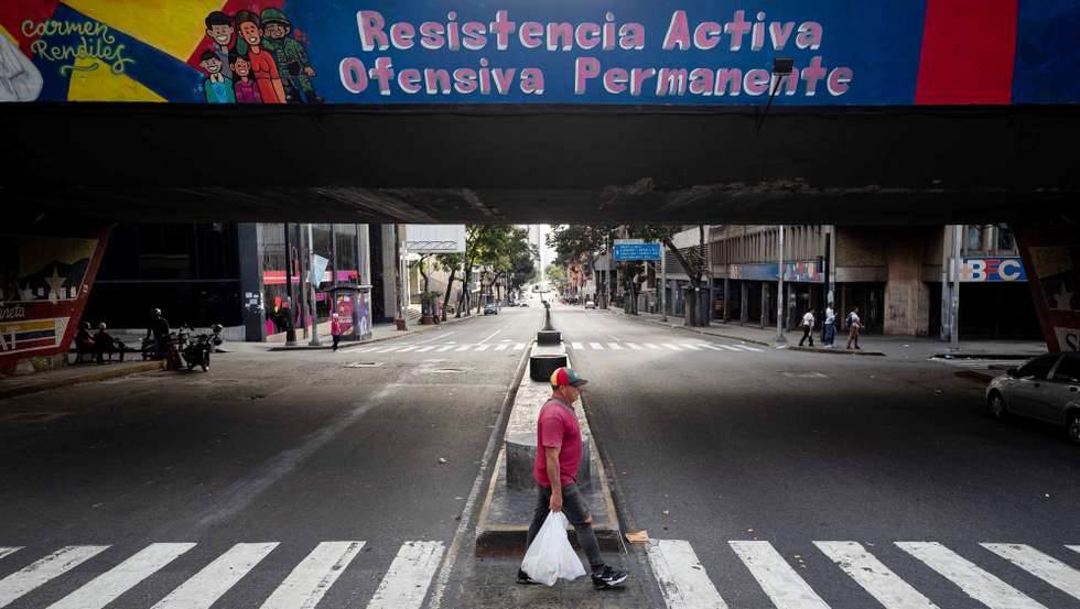 epa12626255 A man crosses a quiet street in Caracas, Venezuela, 04 January 2026. US forces captured Venezuelan President Nicolas Maduro and his wife, Cilia Flores, in a military operation on 03 January 2026. President Maduro and his wife were transported to New York following an indictment issued by the Southern District of New York.  EPA/RONALD PENA R