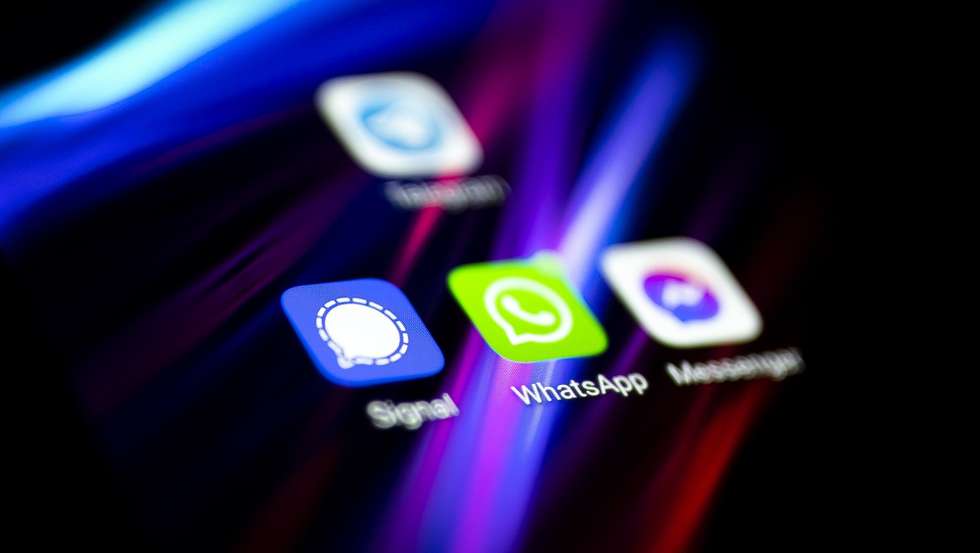 epa08967951 A photo illustration shows the logo of social media messaging application Whatsapp (C) on a mobile telephone screen, in Paris, France, 27 January 2021. The popular application (app) Whatsapp has faced backlash after announcing on 04 January a change to its privacy policy under which users widely interpreted that personal information would be shared with the app's parent company, Facebook. Although the policy change allegedly was only to affect interactions with business accounts, it prompted millions of users to migrate to rival messaging applications such as Signal (L) and Telegram (top).  EPA/IAN LANGSDON