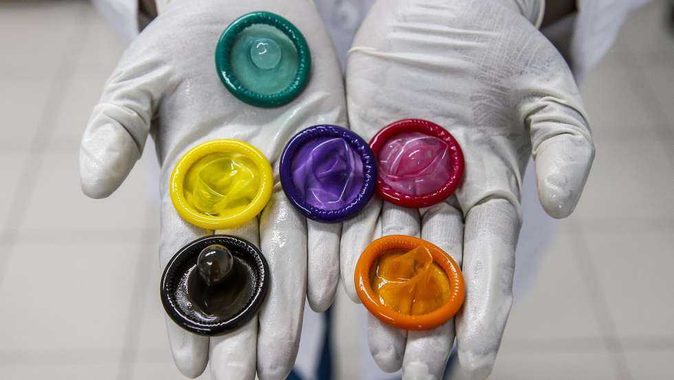 epa07193882 (FILE) - A worker holds a variety of colored condoms at the Karex condom factory in Port Klang, Malaysia, 17 January 2015 (reissued 27 November 2018). The French Health Ministry on 27 November 2018 announced that France is to reimburse the costs of prescribed condoms bought at pharmacies from 10 December 2018 on.  EPA/AZHAR RAHIM *** Local Caption *** 51792702
