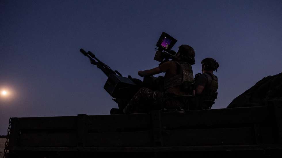 epa12227506 Two soldiers from a Ukrainian Army anti-aircraft artillery brigade scan their sector for Shahed drones on Ukraine's southern frontline on the night Russia launched the largest combined airstrike since it began its full-scale invasion of Ukraine, 08 July 2025. The unit operates a truck-mounted ZU-23-2 air defence system with a twin 23-calibre gun capable of targeting objects flying below 2,500 metres.  EPA/Maria Senovilla