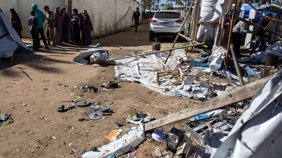 epa12704266 Palestinians inspect the site of an Israeli airstrike that targeted a tent camp sheltering displaced people in Khan Younis in the southern Gaza Strip, 04 February 2026. According to the Palestinian Red Crescent, at least two people were killed and 12 others injured in the attack.  EPA/HAITHAM IMAD