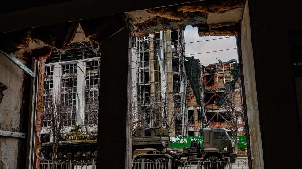 epa12755119 Russian military trucks carry a tank near destroyed buildings in downtown Mariupol, Donetsk region, 16 February 2026 (issued 18 February 2026). The city of Mariupol endured a nearly three-month siege during the early stages of the Russian invasion of Ukraine in February 2022, eventually falling to Russia in May of the same year. The city, strategically located near the Sea of Azov, accounted for the largest Russian-speaking population in Ukraine's eastern Donetsk region.  EPA/STRINGER