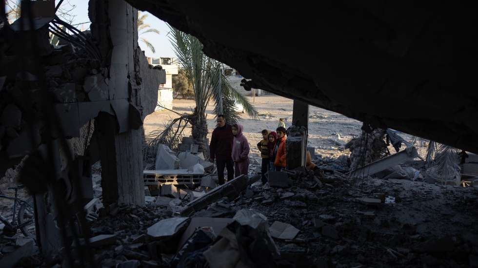 epa11812649 Palestinians inspect the site of an Israeli airstrike in the Khan Yunis camp in southern Gaza, 08 January 2025. At least 20 Palestinians were killed following an Israeli airstrike targeting residential areas in Khan Younis, according to medics at Nasser Hospital. More than 45,800 Palestinians and over 1,400 Israelis have been killed, according to the Palestinian Health Ministry and the Israeli Army, since Hamas militants launched an attack against Israel from the Gaza Strip on 07 October 2023, and the Israeli operations in Gaza and the West Bank which followed it.  EPA/HAITHAM IMAD