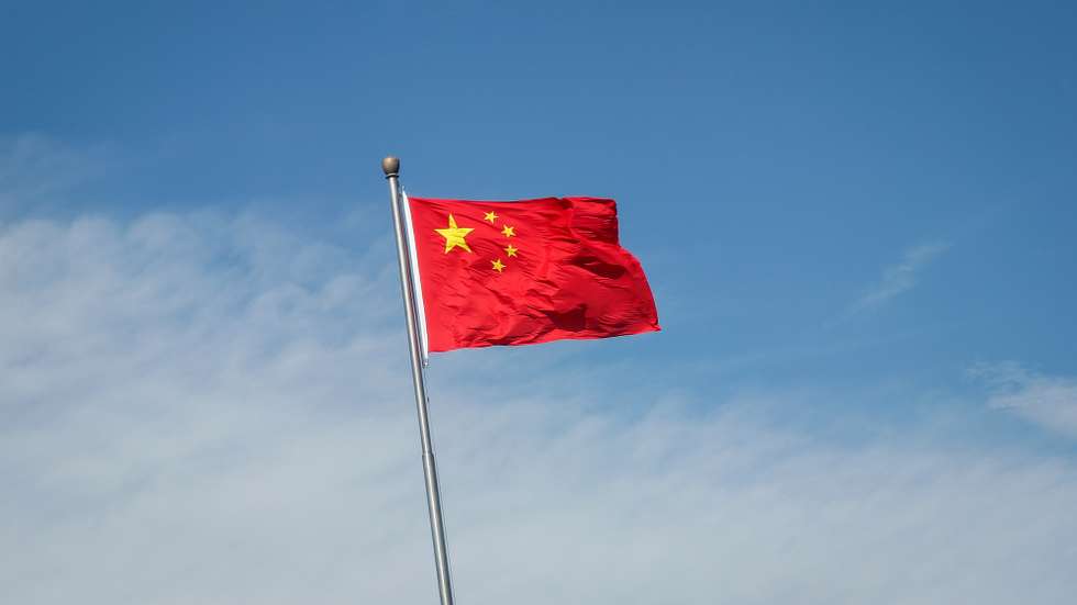 epa10133364 China's flag flutters along a road in Beijing, China, 22 August 2022. China has cut its benchmark loan rates to help revive its economy. China's one year loan prime rate was cut from 3.7 percent to 3.65 percent, while the loan rates for mortgages were cut from 4.45 percent to 4.3 percent, the People's Bank of China (PBOC) said.  EPA/MARK R. CRISTINO