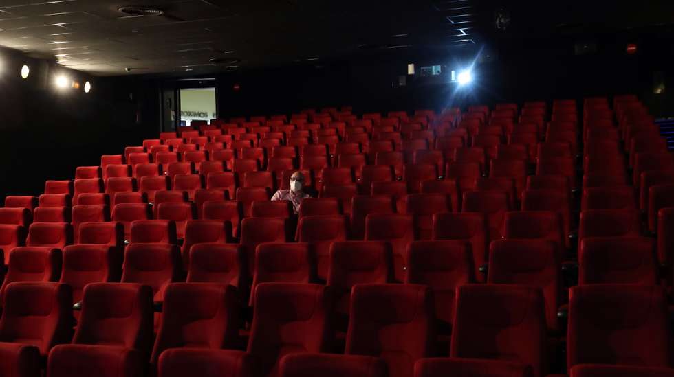 epa08481110 A man wearing a mask watch a movie at Capitol cinema, which reopened his doors after three months, in Madrid, Spain, 12 June 2020. Madrid cinemas resume business are lockdown restrictions are eased amid the ongoing pandemic of the COVID-19 disease caused by the SARS-CoV-2 coronavirus.  EPA/KIKO HUESCA