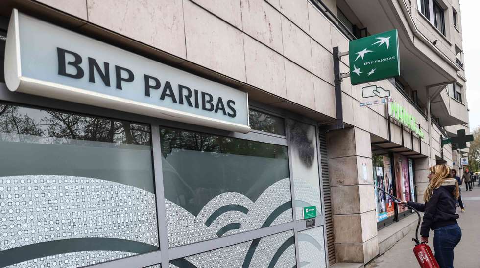 epa10567267 An activist from Extinction Rebellion environmental movement spray paints a branch of BNP Paribas as they denounce the East African Crude Oil Pipeline (EACOP) project of TotalEnergies in East Africa, in Paris, France, 10 April 2023. Activists from Extinction Rebellion movement protest against BNP Paribas, as they concider it as a major financial partner of TotalEnergies, and therefore participating in the financing of the East African Crude Oil Pipeline (EACOP) crossing several African countries.  EPA/Mohammed Badra