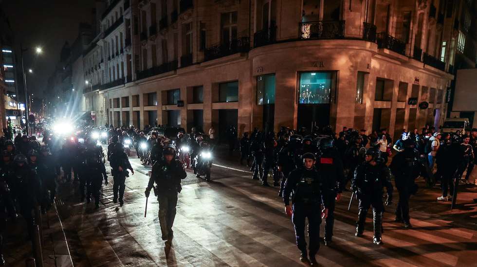 epa10721755 Riot police forces secure the area near the Arc de triomphe amid fears of another night of clashes with protestors in Paris, France, 01 July 2023. Violence broke out all over France after police fatally shot a 17-year-old teenager during a traffic stop in Nanterre on 27 June.  EPA/MOHAMMED BADRA
