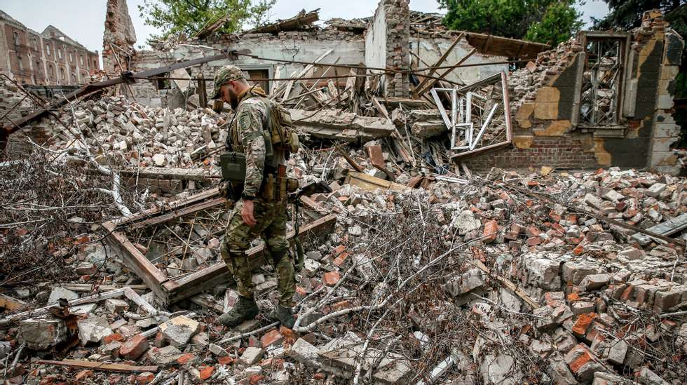 epa10758513 A Ukrainian serviceman of the 24 separate mechanized brigade named after King Danylo, walks amid the ruins of a building destroyed by Russian missile strikes in the Donetsk region, Ukraine, 20 July 2023. The war in Ukraine, which started when Russia entered the country in February 2022, marked in July its 500th day. According to the UN, since the conflict started, more than 9000 civilians have been killed and more than 6 million others are now refugees worldwide.  EPA/OLEG PETRASYUK