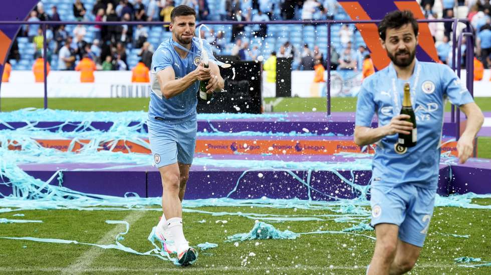 epa09968176 Portuguese players Ruben Dias (L) and Bernardo Silva of Manchester City celebrate after winning the English Premier League title following the English Premier League soccer match between Manchester City and Aston Villa in Manchester, Britain, 22 May 2022.  EPA/ANDREW YATES EDITORIAL USE ONLY. No use with unauthorized audio, video, data, fixture lists, club/league logos or 'live' services. Online in-match use limited to 120 images, no video emulation. No use in betting, games or single club/league/player publications