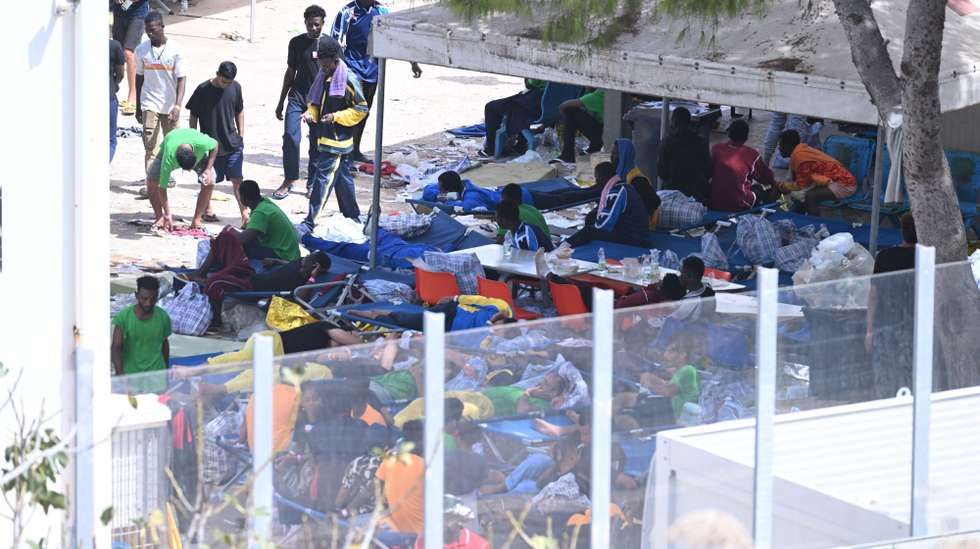 epaselect epa10869349 A group of 1,544 migrants wait to be relocated at Lampedusa, Italy, 19 September 2023. Migrants will be escorted to the island's commercial port, where they will board the Galaxy ferry to Porto Empedocle near Agrigento. The Agrigento Prefecture ordered the relocation. According to ANSA, when migrants disembark, they are asked for their name and personal information, photographed, and given a progressive arrival number. The information gathered is written on a card that they wear around their necks. They are then transferred in the order in which they arrived. They are examined by the Red Cross for their health. The transfers have already begun, but it is currently impossible to predict how long they will last. More ships are expected to arrive on 19 September.  EPA/CIRO FUSCO