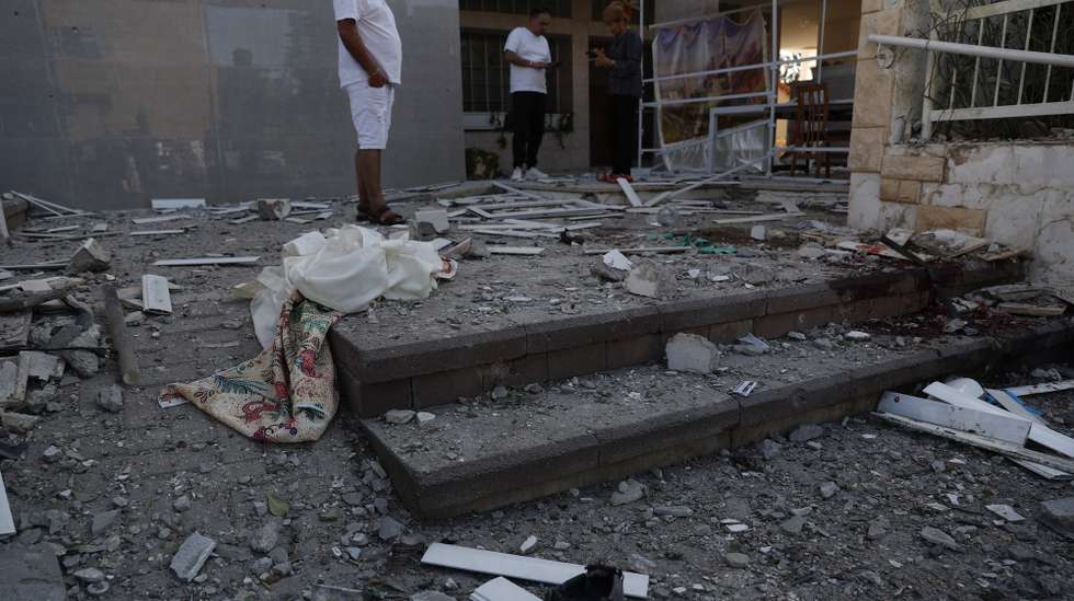 epa10904802 Residents survey the damage in the Israeli city of Ashkelon following rocket launches from Gaza, 07 October 2023. Rocket barrages were launched from the Gaza Strip early Saturday in a surprise attack claimed by the Islamist movement Hamas.  EPA/ATEF SAFADI