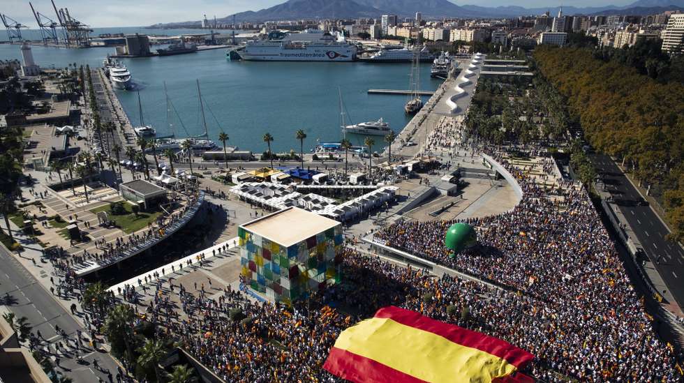 epa10971534 Protesters carry a giant Spanish flag as they attend a demonstration called by right wing parties against the so-called Amnesty Law, in Malaga, Spain, 12 November 2023. Spain's ruling party PSOE struck a deal with Catalan pro-independence party Junts per Catalunya (JxCat), led by former Catalan President Carles Puigdemont, so that Spain's acting Prime Minister Pedro Sanchez can be invested for a second term. In exchange for the key support of his seven JxCat MPs, Puigdemont demanded an amnesty for hundreds of people who faced legal action over their roles in Catalonia's failed push for independence in 2017.  EPA/JORGE ZAPATA