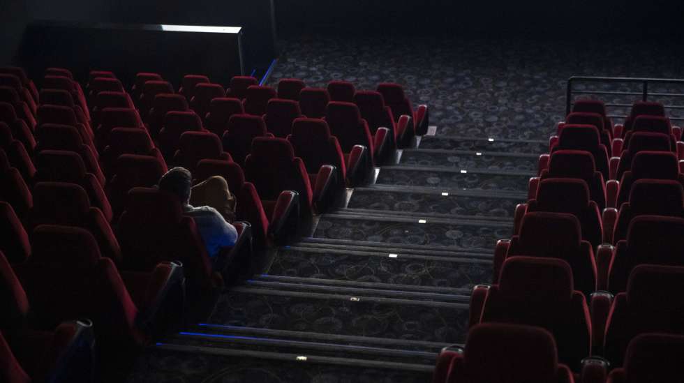 epa08289915 A sole spectator watches a film at a movie theatre in Budapest, Hungary, 12 March 2020. Effective of 12 March, cinemas are restricted to sell a maximum of 99 tickets for a show as on the previous day the Hungarian government declared a state of emergency in response to the novel coronavirus, and prohibited all indoor events with more than 100 participants and outdoor events attended by more than 500 participants. Three more cases have emerged in Hungary on 12 March 2020, bringing the number of confirmed cases of Covid-19 in the country to 16, including nine Iranian, six Hungarian and one British citizens.  EPA/Marton Monus HUNGARY OUT