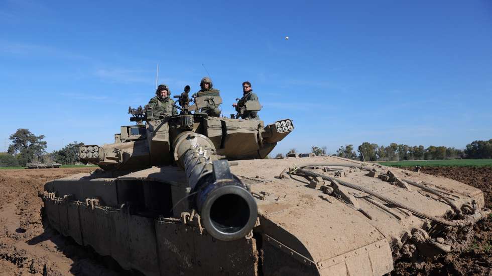 epa11135822 Israeli soldiers sit atop their tank near the Israeli border with Gaza Strip, at an undisclosed location in southern Israel, 08 February 2024. More than 27,500 Palestinians and over 1,300 Israelis have been killed, according to the Palestinian Health Ministry and the Israel Defense Forces (IDF), since Hamas militants launched an attack against Israel from the Gaza Strip on 07 October 2023, and the Israeli operations in Gaza and the West Bank which followed it.  EPA/ABIR SULTAN