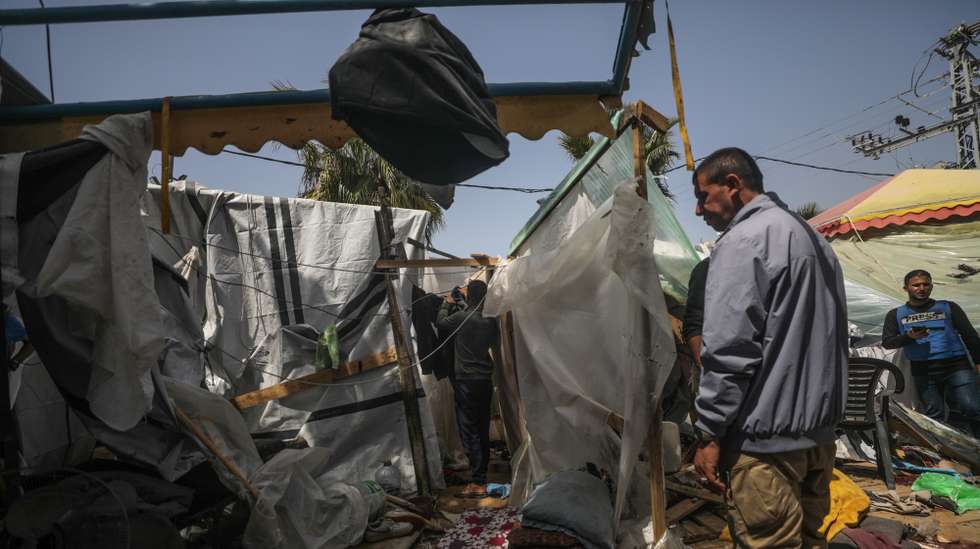 epaselect epa11252939 Palestinians inspect a destroyed shelter tents following an Israeli air strike near Al Aqsa hospital, in Deir Al Balah town in southern Gaza Strip, 31 March 2024. Three Palestinian journalists were wounded and two displaced persons were killed in the air strike, according to Palestinian Civilian Defence. More than 32,700 Palestinians and over 1,450 Israelis have been killed, according to the Palestinian Health Ministry and the Israel Defense Forces (IDF), since Hamas militants launched an attack against Israel from the Gaza Strip on 07 October 2023, and the Israeli operations in Gaza and the West Bank which followed it.  EPA/MOHAMMED SABER