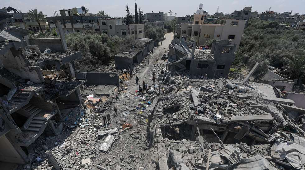 epaselect epa11280118 Palestinians inspect their destroyed houses in Al Maghazi refugee camp, central Gaza Strip, 15 April 2024, following Israeli air strikes. More than 33,700 Palestinians and over 1,450 Israelis have been killed, according to the Palestinian Health Ministry and the Israel Defense Forces (IDF), since Hamas militants launched an attack against Israel from the Gaza Strip on 07 October 2023, and the Israeli operations in Gaza and the West Bank which followed it.  EPA/MOHAMMED SABER