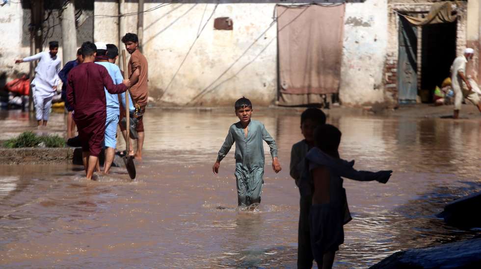 epa11282110 People wade through a flooded street after heavy rain in Charsadda District, Khyber Pakhtunkhwa province, Pakistan, 16 April 2024. Pakistan's southwest region has been in the grip of heavy rainfall for days, with at least 39 people reported dead. Among the victims were farmers struck by lightning while working in wheat fields, according to authorities. According to the Khyber Pakhtunkhwa (KP) provincial disaster management authority, 32 others have been injured in the last four days due to lightning strikes and incidents related to torrential rains affecting several provinces. Pakistan is among the world's top 10 countries most-affected by climate change.  EPA/BILAWAL ARBAB