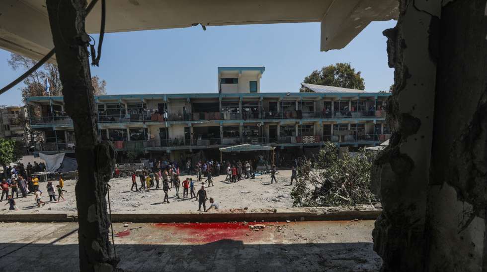 epa11392776 Palestinians inspect a destroyed UNRWA school following an Israeli air strike in Al Nusairat refugee camp in the central Gaza Strip, 06 June 2024. According to the Palestinian News Agency Wafa, at least 32 people  were killed and dozens others were injured on early 06 June following an Israeli strike on a UNRWA school sheltering displaced Palestinians, located in the Nuseirat refugee camp in the central Gaza strip. The Israeli army said that it had "conducted a precise strike on a Hamas compound", whose members were " embedded in the UNRWA school".  More than 36,000 Palestinians and over 1,400 Israelis have been killed, according to the Palestinian Health Ministry and the Israel Defense Forces (IDF), since Hamas militants launched an attack against Israel from the Gaza Strip on 07 October 2023, and the Israeli operations in Gaza and the West Bank which followed it.  EPA/MOHAMMED SABER