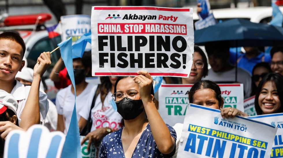 epa11403256 A protester (C) holds a sign supporting Philippine fishing workers during a rally against China's alleged harassment toward Philippine contingents in disputed waters of the South China Sea, outside China's consular office in Makati City, Metro Manila, Philippines, 11 June 2024. The protesters claim that the Chinese Coast Guard and defense units have been conducting aggressive maneuvers against Philippine vessels and endangered the lives of Philippine contingents in various areas of the disputed waters.  EPA/ROLEX DELA PENA