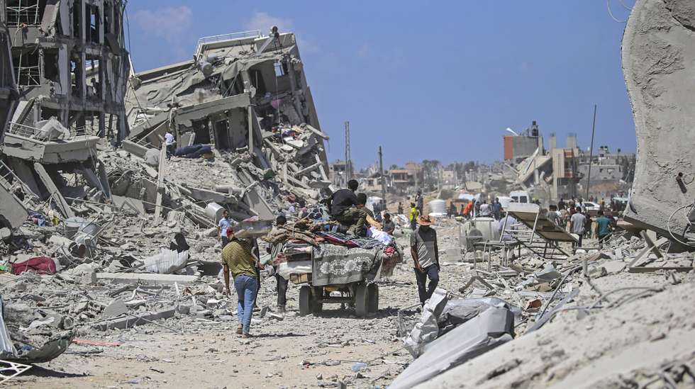 epaselect epa11572800 Internally displaced Palestinians walk past their destroyed houses as they return to Deir Al Balah town after the Israeli military pulled out troops from the east central Gaza Strip, 29 August 2024.More than 40,000 Palestinians and over 1,400 Israelis have been killed, according to the Palestinian Health Ministry and the Israel Defense Forces (IDF), since Hamas militants launched an attack against Israel from the Gaza Strip on 07 October 2023, and the Israeli operations in Gaza and the West Bank which followed it.  EPA/MOHAMMED SABER