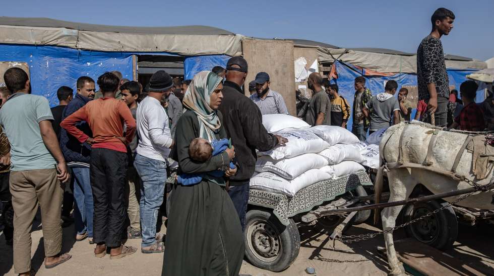 epa11693917 Palestinians receive bags of flour handed out by a United Nations Relief and Works Agency for Palestine Refugees in the Near East (UNRWA) aid distribution center in Khan Younis, southern Gaza Strip, 31 October 2024. According to the UN, at least 1.9 million people (or nine in ten people) across the Gaza Strip are internally displaced, including people who have been repeatedly displaced. Since October 2023, only about 11 percent of the Gaza Strip has not been placed under Israeli-issued evacuation orders, the UN aid coordination office OCHA said.  EPA/HAITHAM IMAD