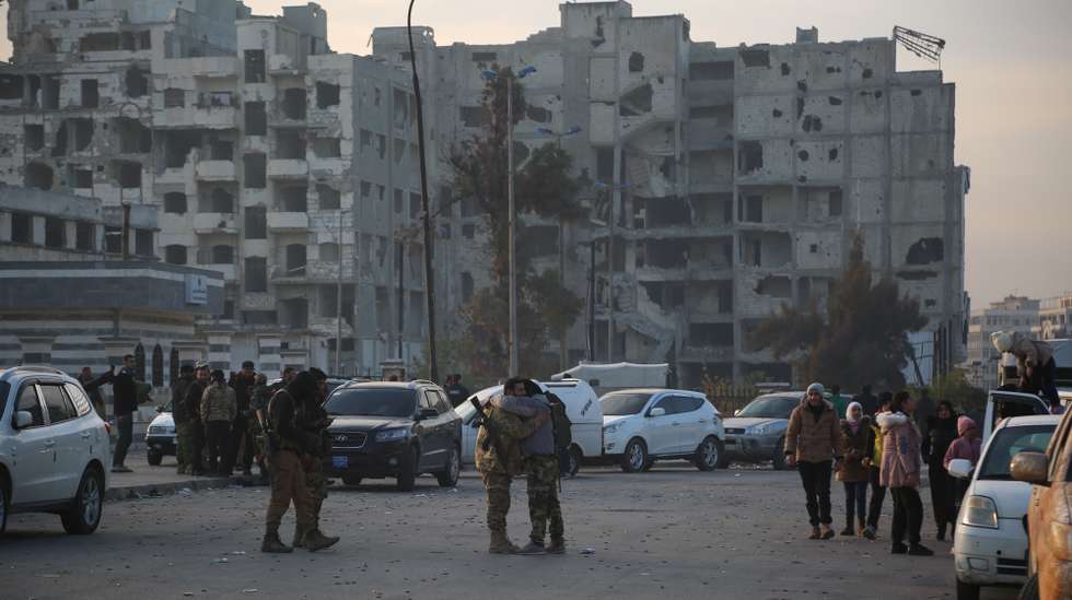 epa11765730 Syrian rebels gather in Homs, Syria, 08 December 2024. Syrian rebels entered Damascus on 08 December 2024 and announced in a televised statement the 'Liberation of the city of Damascus and the overthrow of Bashar al-Assad', as well as the release of all the prisoners. The rebels also urged the Syrian armed forces to leave Syrian public institutions, which will stay under the control of the outgoing Syrian prime minister until the official handover ceremony.  EPA/BILAL AL HAMMOUD