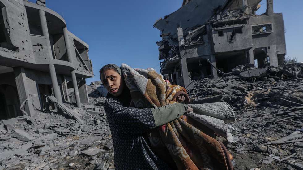 epa11803385 A Palestinian girl inspects the destroyed house of her family following an Israeli air strike in Al Maghazi refugee camp, central Gaza Strip, 03 January 2025. According to reports from the Ministry of Health in Gaza at least nine members of the Abu Libda family were killed following an Israeli air strike in the refugee camp. More than 45,500 Palestinians and over 1,400 Israelis have been killed, according to the Palestinian Health Ministry and the Israeli Army, since Hamas militants launched an attack against Israel from the Gaza Strip on 07 October 2023 and the Israeli operations in Gaza and the West Bank that followed it.  EPA/MOHAMMED SABER