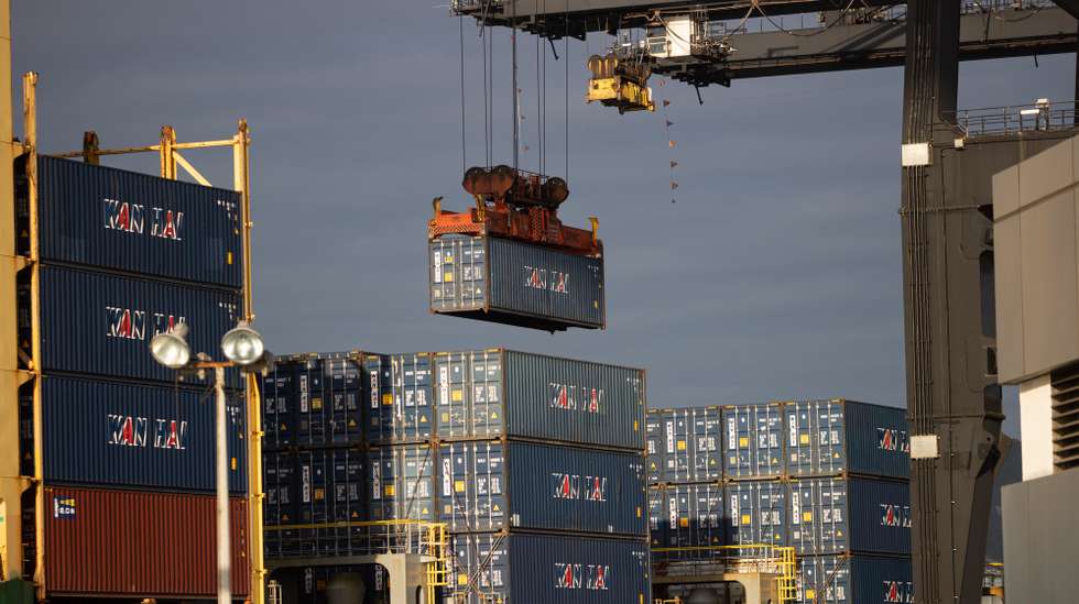 epa10349240 A crane loads containers into a container ship berthed in the Kwai Tsing Container Terminals in Hong Kong, China, 05 December 2022. For the first nine months of 2022, total port cargo throughput decreased by 9.8 per cent compared with the first nine months of 2021 to 144.0 million tonnes according to Hong Kongs Census and Statistics Department.  EPA/JEROME FAVRE