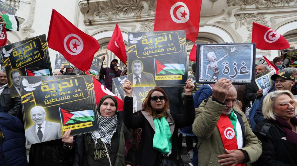 epa11823844 Protesters carry placards with photos of political prisoners and reading in Arabic 'Freedom from Tunisian prisons to Palestine' during a protest rally organized by the National Salvation Front opposition coalition against Tunisian President Kais Saied, at the Avenue Habib Bourguiba in Tunis, Tunisia, 14 January 2025. The rally marks the 14th anniversary of the uprising that ousted former Tunisian president Zine El Abidine Ben Ali. The former Tunisian president Ben Ali and his wife fled into exile in Saudi Arabia on 14 January 2011.  EPA/MOHAMED MESSARA