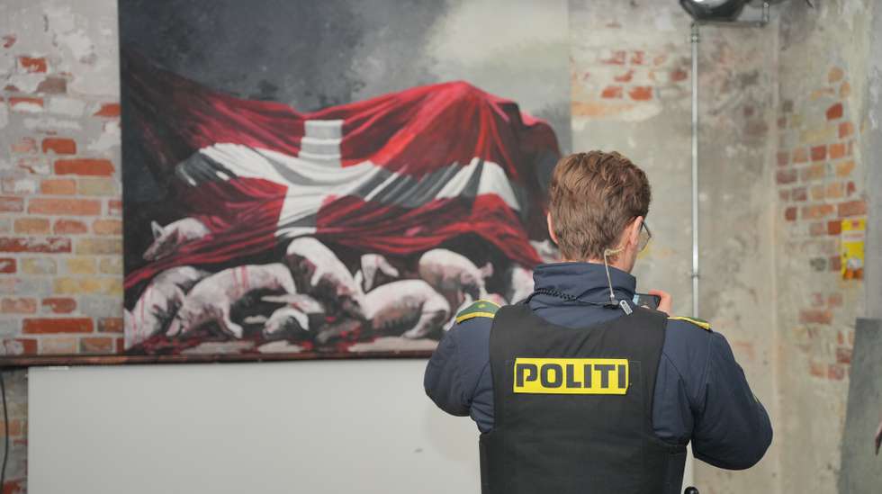 epa11930508 Police examine the exhibition "And Now You Care" by Marco Evaristti before the opening in Den Graa Koedby in Copenhagen, Denmark, 28 February 2025. Three live piglets are in a pen made of two shopping carts and are to die either by starving or if a visitor kills them with a bolt gun. Evaristti aims to draw atention to the tens of thousands of piglets that die in pig production in Denmark.  EPA/Emil Nicolai Helms  DENMARK OUT