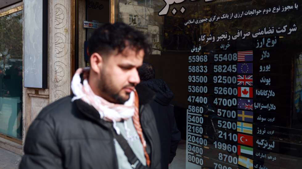 epa11780384 A man walks past a currency exchange shop in Tehran, Iran, 16 December 2024. Iranians are facing an economic crisis that, due to recent tension between Iran, Israel, and the US, has extended.Â   EPA/ABEDIN TAHERKENAREH