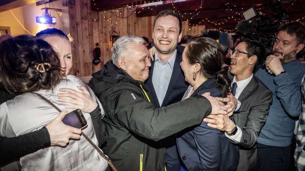 epa11957614 Chairman of Demokraatit, Jens-Frederik Nielsen (C) embraces his supporters during the election party for Demokraatit at Cafe Killut in Nuuk, Greenland, 11 March 2025 (issued 12 March 2025). Demokraatit is the leading party in Greenland's elections with 29.9 percent of the votes.  EPA/Mads Claus Rasmussen  DENMARK OUT