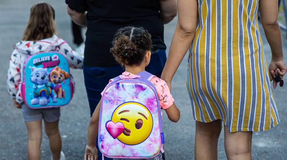 epa10839373 Schoolchildren and parents arrive at the 'Bois de l'Etang' school for the start of the new school year in La Verriere, west of Paris, France, 04 September 2023. The elementary school of this Paris’ suburb was destroyed  during the riots sparked by the death of a young man killed by a police officer during a traffic stop in June 2023.  EPA/CHRISTOPHE PETIT TESSON