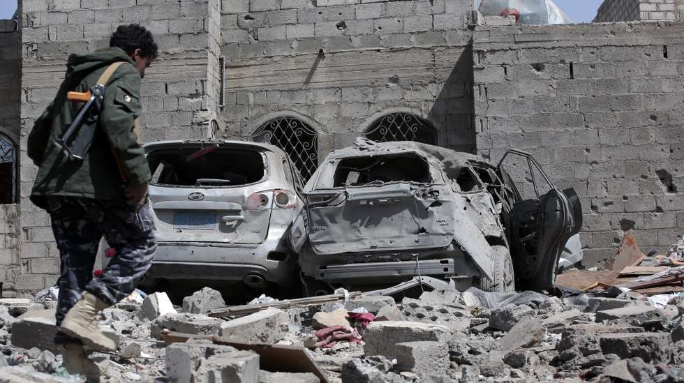 epa12015453 An armed man inspects the damage after a US airstrike in Sana'a, Yemen, 07 April 2025. According to the Ministry of Health in the Houthi-administrated Sana'a, at least four were killed and 25 injured in a US airstrike on a residential building in the Sha'ub district on 06 April.  EPA/OSAMAH YAHYA