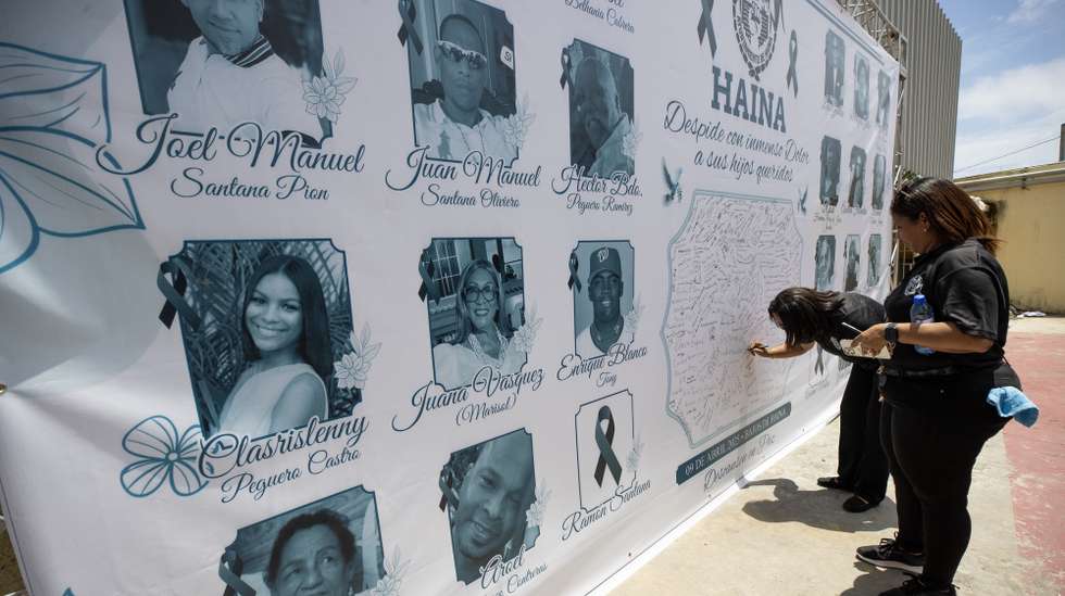 epa12023669 A poster with the portraits of people who died due to the roof collapse at the Jet Set nightclub, in Haina, Dominican Republic, 10 April 2025. The authorities of the Dominican Republic confirmed 221 deaths due to the collapse of the roof of a popular nightclub in Santo Domingo, that occurred early 08 April morning.  EPA/ORLANDO BARRIA