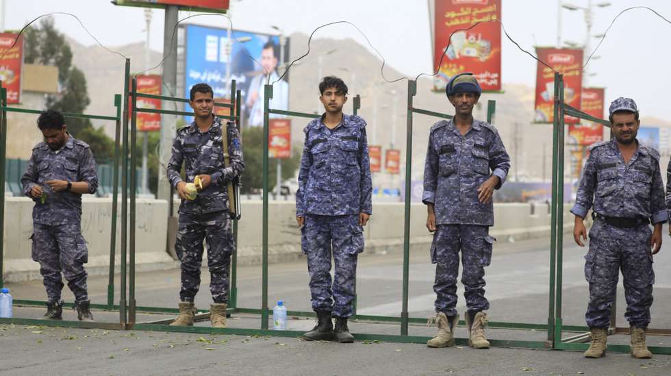 epa12087692 Houthi soldiers patrol a street in front of a digital billboard featuring Houthi leader Abdul-Malik al-Houthi in Sana'a, Yemen, 9 May 2025. Yemen's Houthis claimed to have launched a hypersonic missile at Israelâ€™s Ben Gurion Airport and a drone strike on Tel Aviv, as part of efforts to enforce an air blockade in response to Israeli attacks on Gaza, Houthi military spokesman Yahya Sarea said.  EPA/YAHYA ARHAB