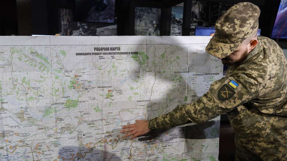 epa12143127 A Ukrainian serviceman shows a seized Russian military map, transferred to the collection of the Museum of History of Ukraine in WWII as part of the permanent exhibition in Kyiv, Ukraine, 29 May 2025, amid the Russian invasion. Approximately 200 items, including fragments of Russian drones, personal weapons, equipment, sleeve insignia, and awards, were handed over. These artifacts, obtained by servicemen of the 225th Separate Assault Regiment of the Armed Forces of Ukraine during combat with the Russian Army, will become part of the permanent exhibition dedicated to the Russian invasion of Ukraine.  EPA/SERGEY DOLZHENKO