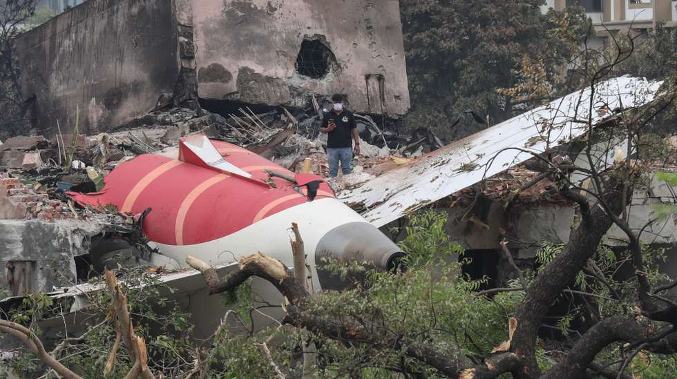 epaselect epa12172810 An official inspects the site of an airplane crash near Sardar Vallabhbhai Patel International Airport in Ahmedabad, Gujarat, western India, 13 June 2025. Air India flight AI171, bound for London carrying 242 passengers and crew members on board a Boeing 787-8 aircraft, crashed minutes after take-off in the Meghaninagar area of Ahmedabad.  EPA/RAJAT GUPTA