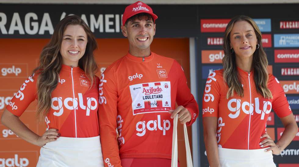 Argentinian rider Nicolas Tivani (C) celebrates on stage after winning the first stage of the 86th Volta a Portugal over 162.3 km between Viana do Castelo and Sameiro, in Braga, Portugal, 07 August 2025. TIAGO PETINGA/LUSA