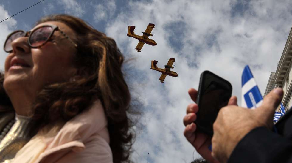 epaselect epa11242670 Canadair aircrafts take part in a military parade marking Greece's Independence Day in Athens, Greece, 25 March 2024. The national holiday on 25 March marks the start of Greece's 1821 war of independence against the 400-year Ottoman rule.  EPA/GEORGE VITSARAS