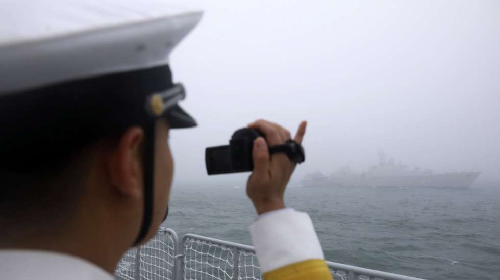 epa07523339 Chinese navy personnel takes video to Vietnamese frigate Dinh Tien Hoang (HQ-011) during the Navy parade to celebrate the 70th anniversary of the Chinese People's Liberation Army (PLA) Navy in Qingdao, China's Shandong province, 23 April 2019.  EPA/WU HONG