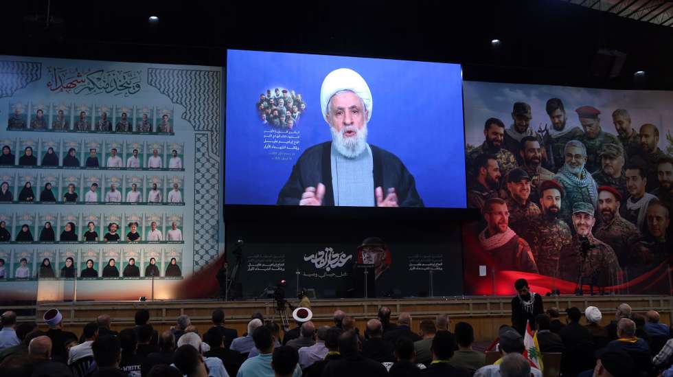 epa12390324 Hezbollah Secretary-General Naim Qassem (C, screen) delivers a televised speech to mark the first anniversary of the killing of senior Hezbollah commander Ibrahim Aqil, in the Dahieh suburb of Beirut, Lebanon, 19 September 2025. The Hezbollah top commander was killed on 20 September 2024 by an Israeli airstrike in the southern suburbs of Beirut.  EPA/WAEL HAMZEH