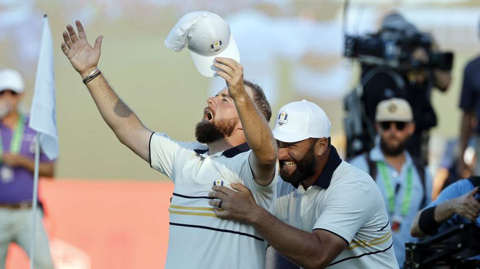 epa12413649 Shane Lowry of Europe (L) is congratulated by teammate Jon Rahm (R) after securing the Ryder Cup for Europe during the singles matches of the 2025 Ryder Cup golf tournament at the Bethpage Black Golf Course in Farmingdale, New York, USA, 28 September 2025.  EPA/ERIK S. LESSER