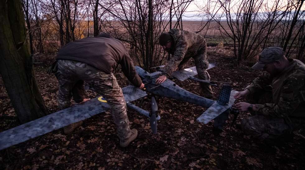 epa12501027 Pilots from the Predator Brigade's unmanned vehicle unit of the Ukrainian Patrol Police in Donetsk assemble a GARA bomber drone on a nighttime strike mission against Russian forces on the Pokrovsk front line, Ukraine, 02 November 2025 (issued 03 November 2025). Russian offensives have intensified in the area in recent weeks.  EPA/MARIA SENOVILLA