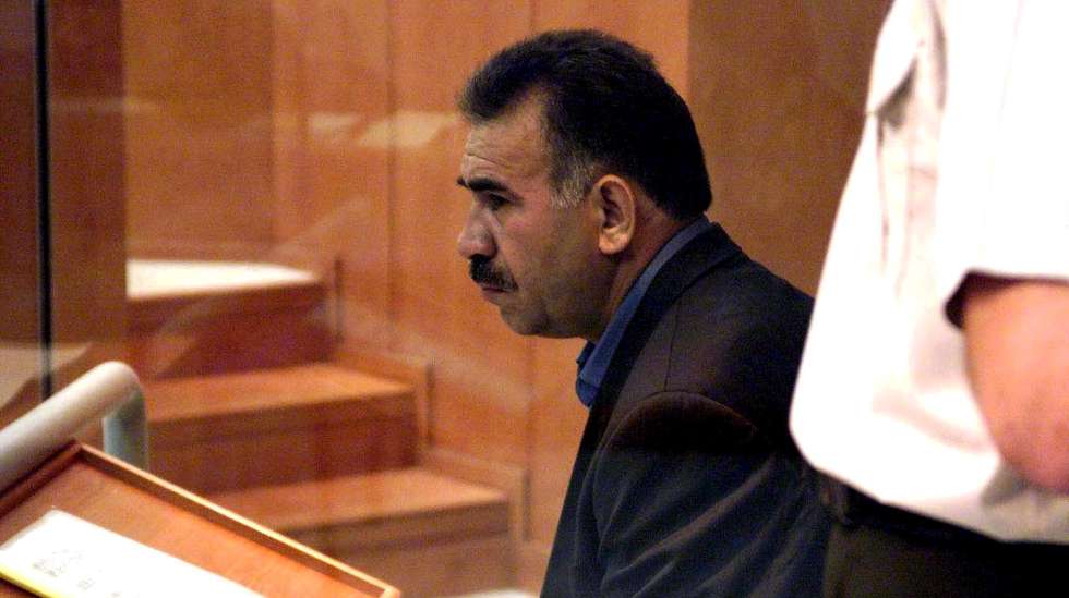 epa12094347 (FILE) Abdullah Ocalan, leader of the Kurdistan Workers Party PKK, sits amidst tight security in a bullet-proof case during his trial at the military prison at Imrali island off Turkish coast, 31 May 1999 (re-issued 12 May 2025). The Kurdistan Workers' Party (PKK) declared on 12 May 2025 that it had 'successfully achieved its historic mission' and announced its decision to dismantle the PKK's organizational structure and 'end the practice of armed struggle.'  EPA/HURRIYET *** Local Caption *** 99407433