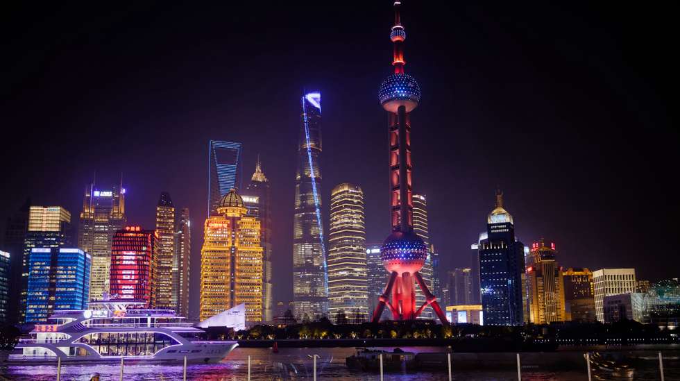 epa12646252 People skate on a cargo ship turned into an ice skating rink on the Huangpu River in Shanghai, China, 13 January 2026.  EPA/ALEX PLAVEVSKI